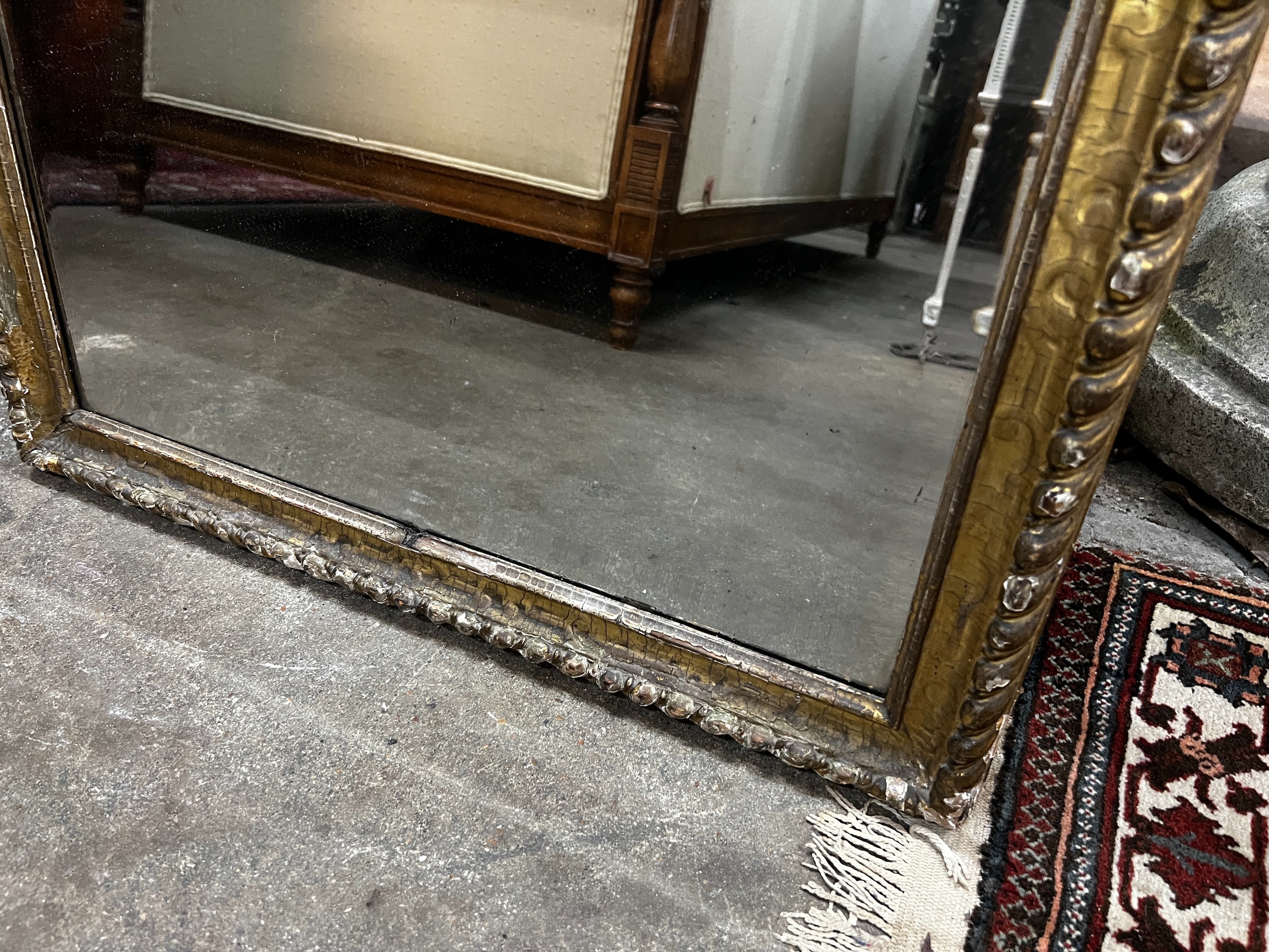 A Regency painted gilt and gesso pier glass with musical trophy tablet, width 62cm, height 124cm
